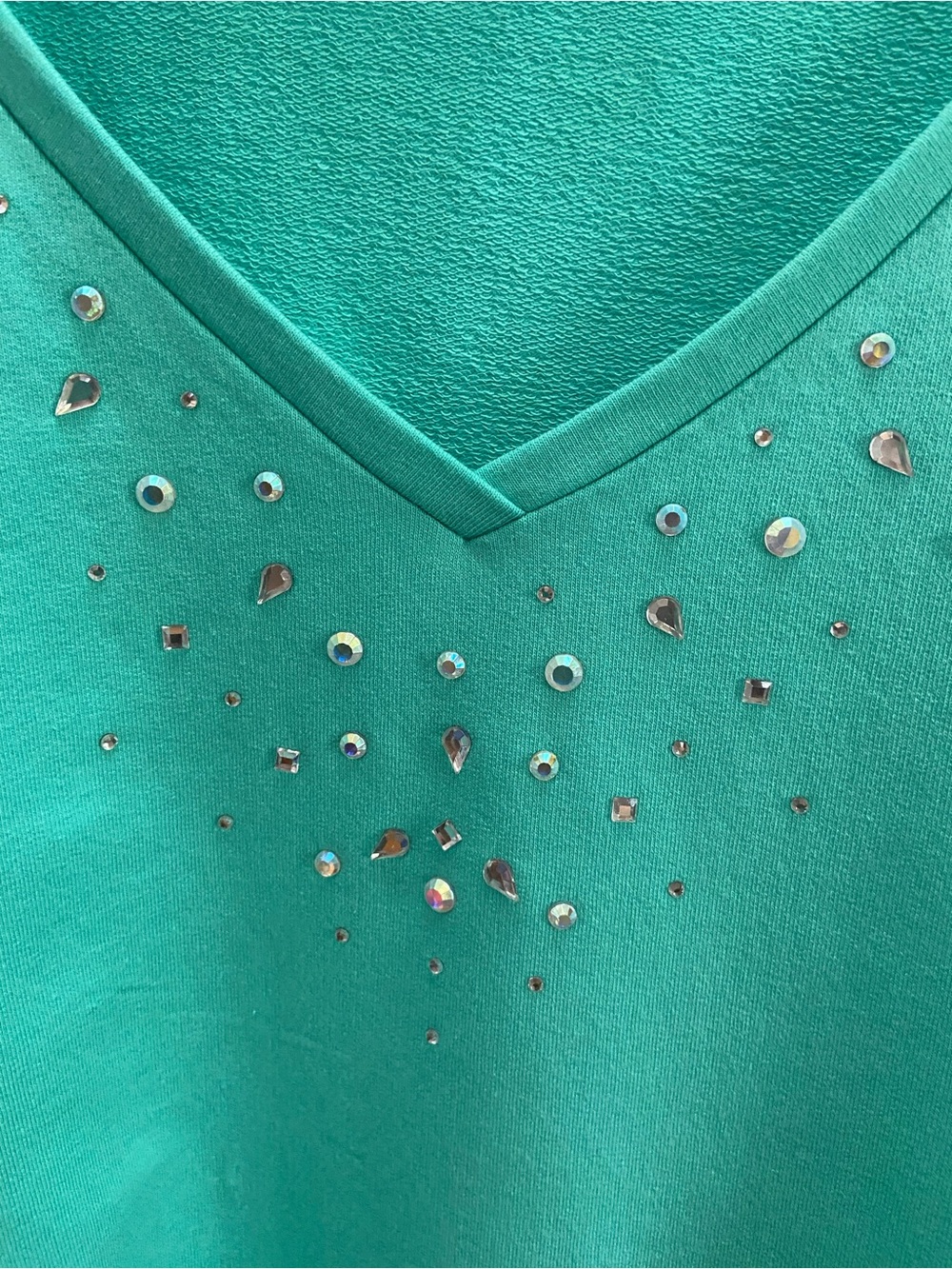 Quacker Factory teal  V-Neck top 
with Sparkling Rhinestones 
on neck & pockets.